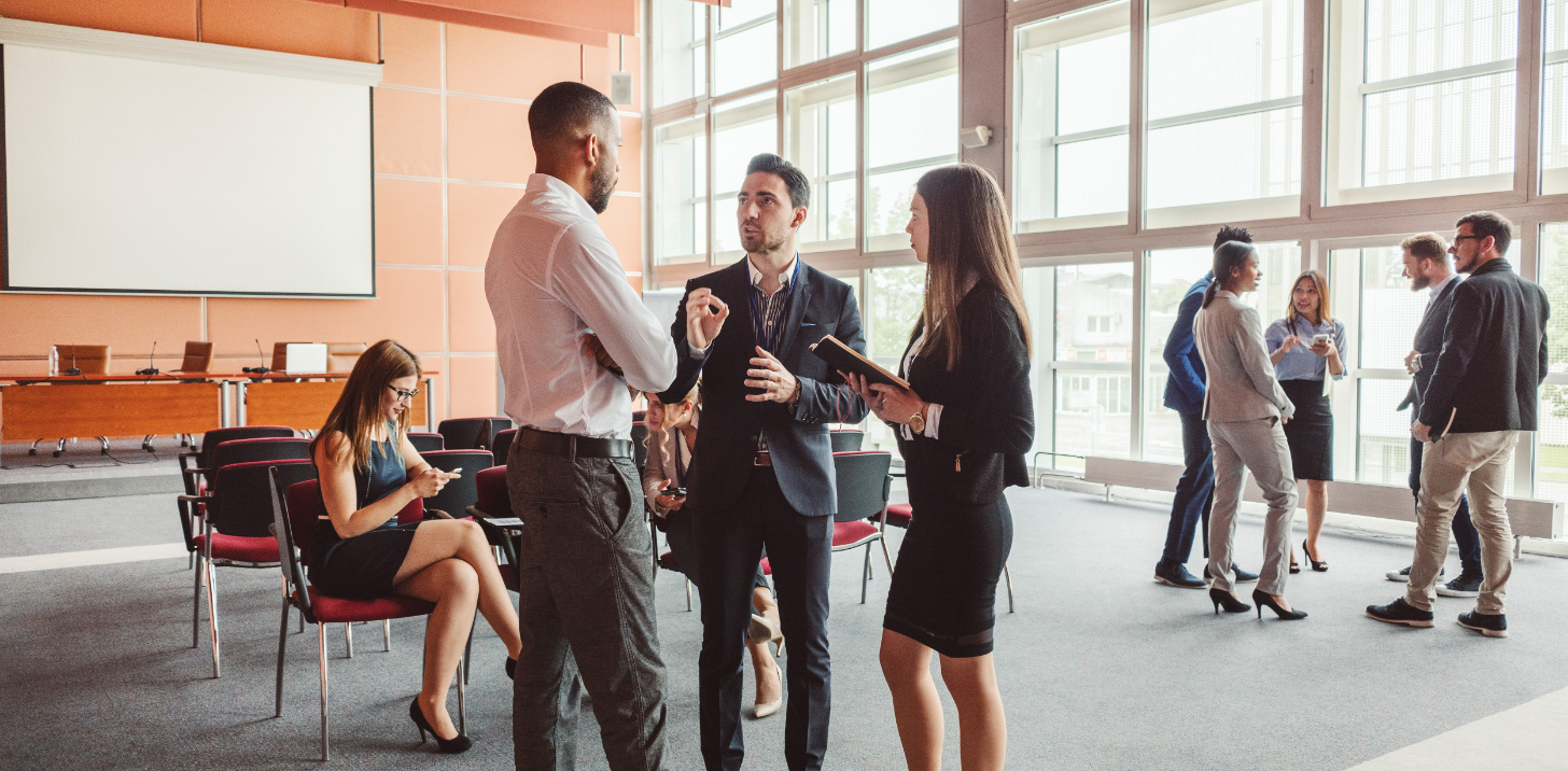 Young professionals talking to each other | AVIXA